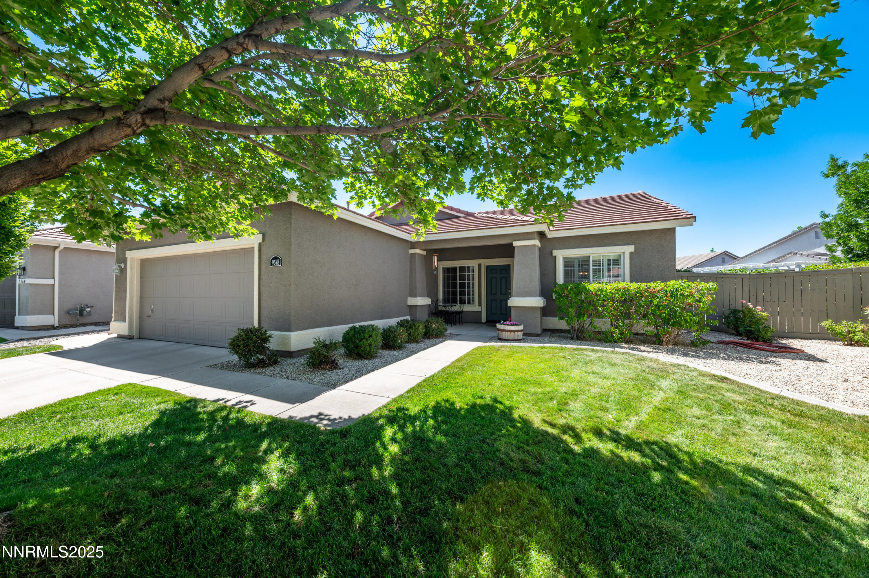 9578 Rusty Nail Court Reno, NV 89521 - Photo 3 of 38 a house that has a tree in front of it
