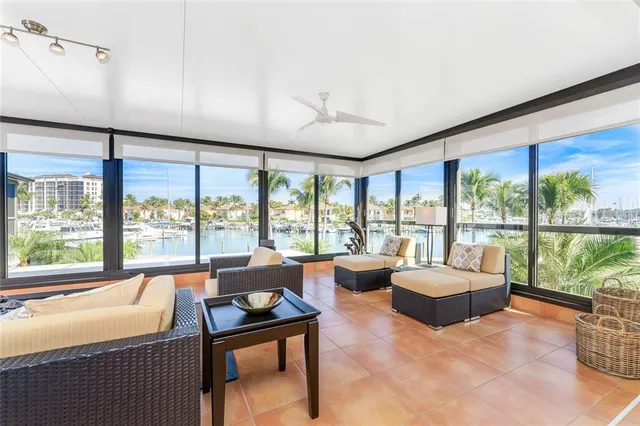 a bedroom with furniture and large windows