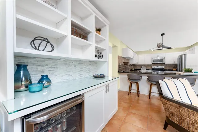 a view of hallway with a chair and frames on the wall