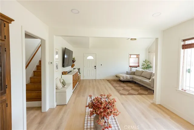 a view of a living room hardwood floor and a window