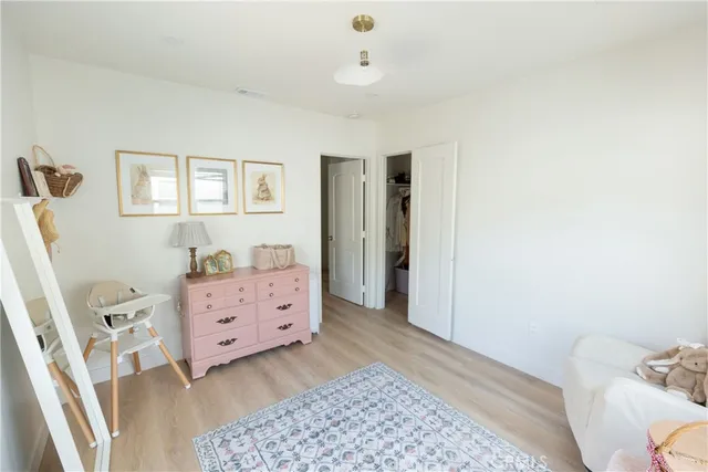 a bedroom with a bed and a dresser in it