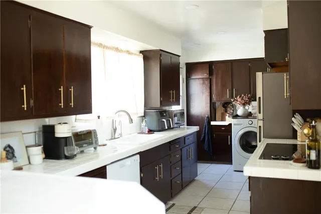 a kitchen with a sink stove and refrigerator