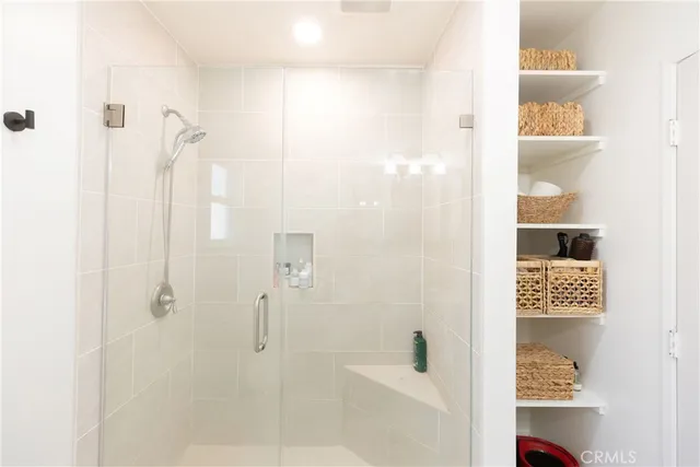 a bedroom with two beds and a flat screen tv