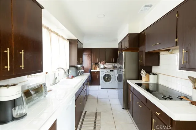 a kitchen with a sink stove and cabinets