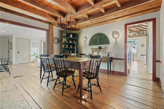 a dining room with furniture window and wooden floor