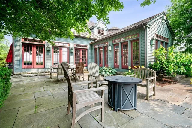 a view of a house with backyard and sitting area