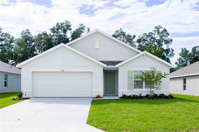 a view of a house with a yard and garage