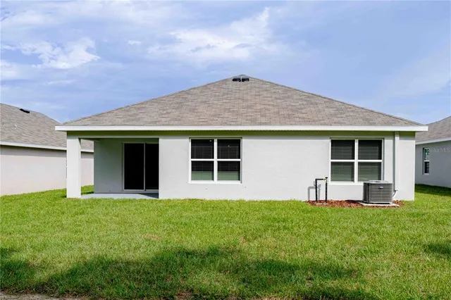 a front view of a house with a yard and porch