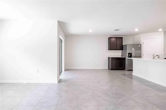 a view of kitchen with microwave and cabinets