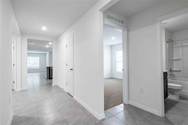a view of a hallway with wooden shelves