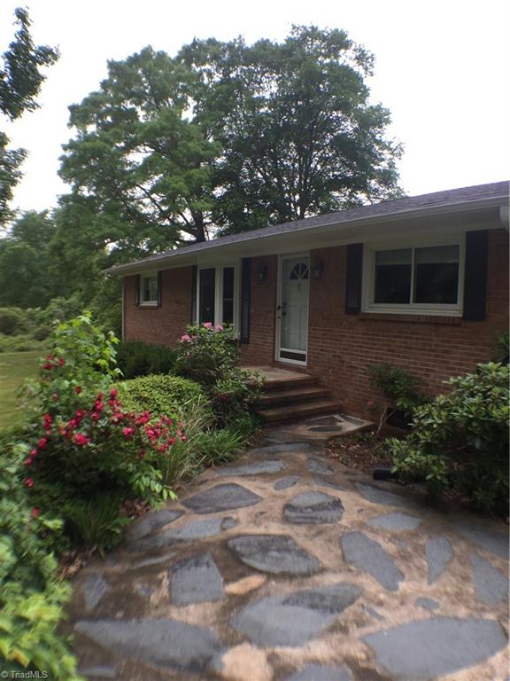 310 McCoy Road Reidsville, NC 27320 - Photo 1 of 19 Brick ranch with lots of beautiful plants