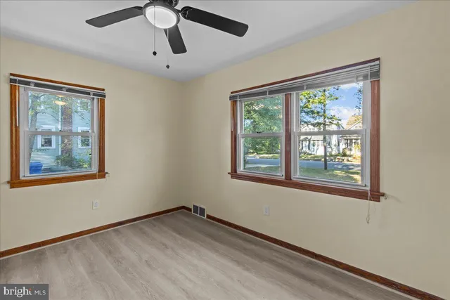 a view of empty room with ceiling fan