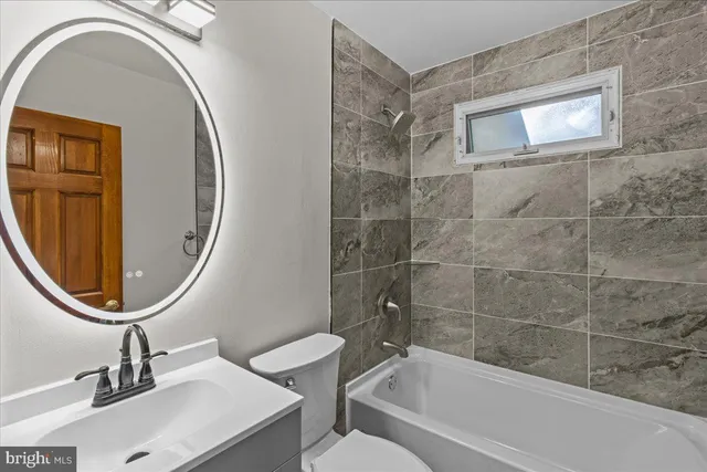 a bathroom with a sink a mirror and a bathtub