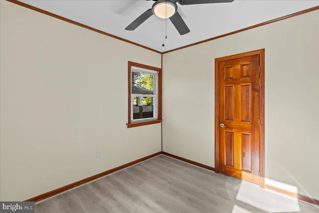 an empty room with windows and closet