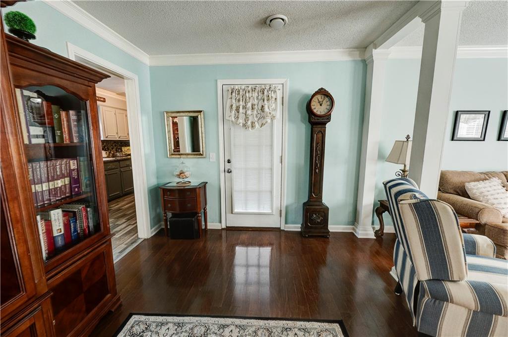 651 Camelot Circle Northwest Calhoun, GA 30701 - Photo 15 of 56 a living room with furniture a bookshelf and a window