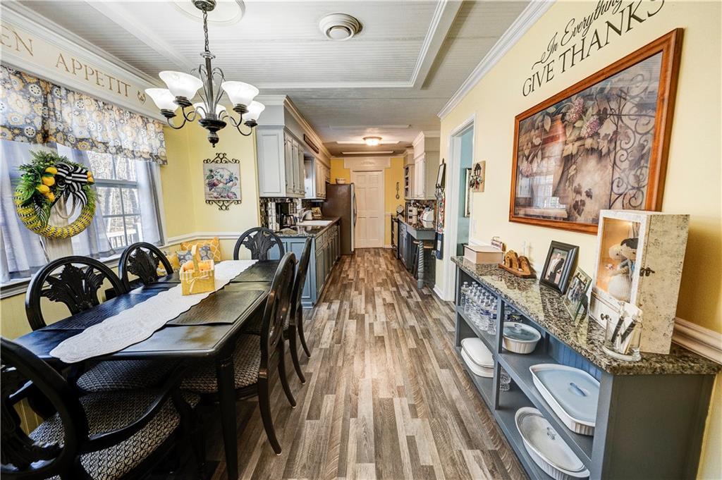 651 Camelot Circle Northwest Calhoun, GA 30701 - Photo 16 of 56 a view of a dining room with furniture and chandelier