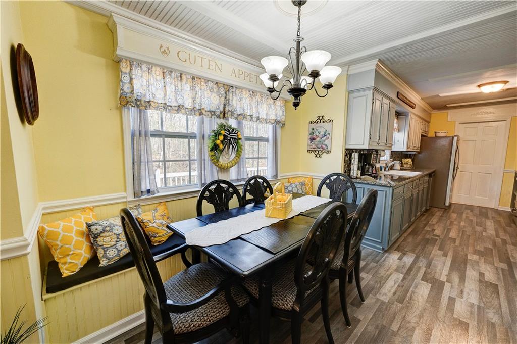 651 Camelot Circle Northwest Calhoun, GA 30701 - Photo 17 of 56 a view of a dining room with furniture a livingroom and chandelier