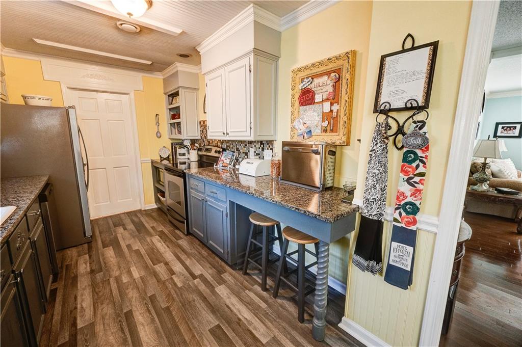 651 Camelot Circle Northwest Calhoun, GA 30701 - Photo 20 of 56 a kitchen with stainless steel appliances a stove and a refrigerator
