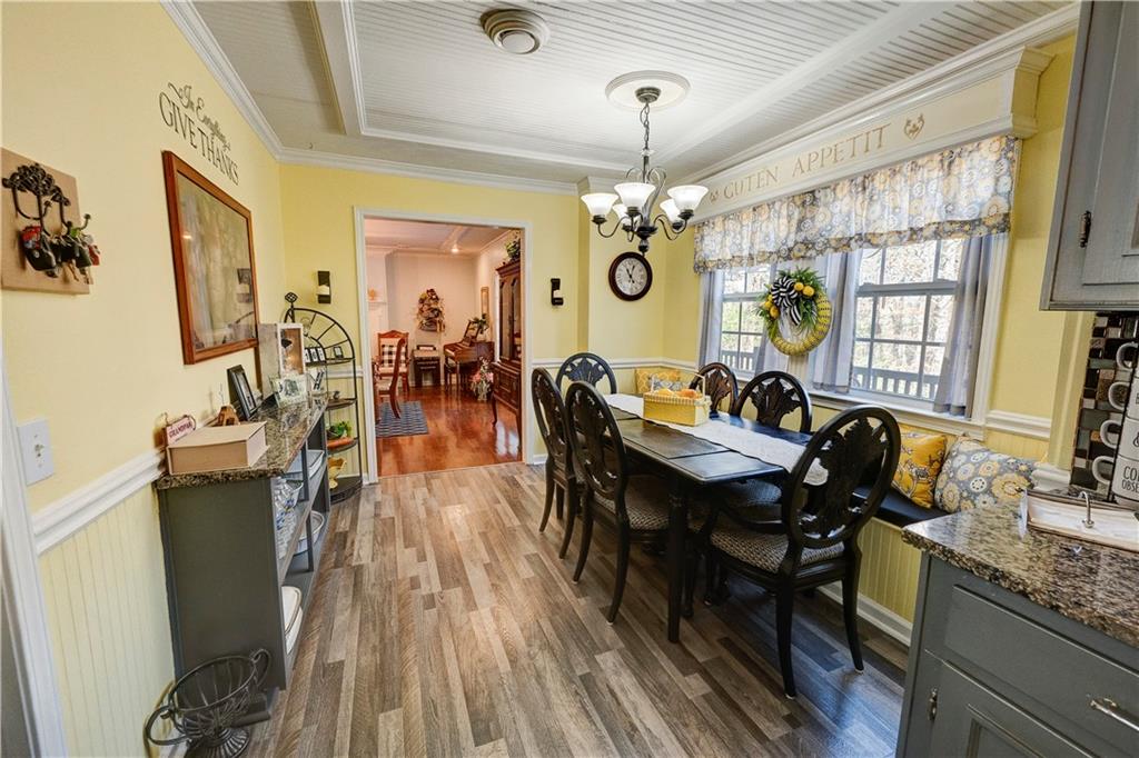 651 Camelot Circle Northwest Calhoun, GA 30701 - Photo 24 of 56 a view of a dining room with furniture a chandelier and wooden floor