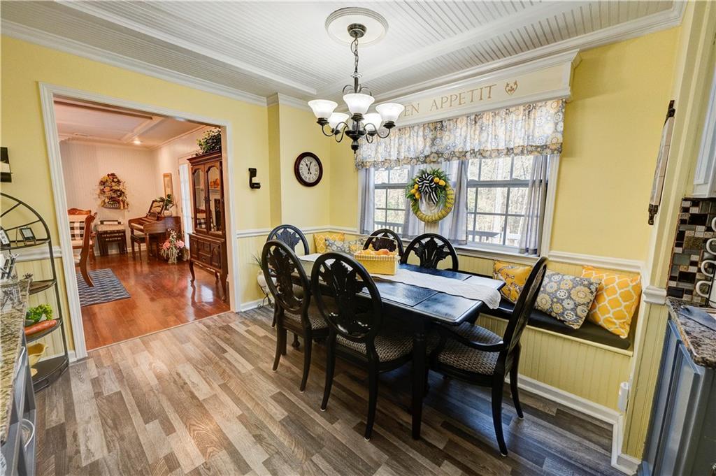 651 Camelot Circle Northwest Calhoun, GA 30701 - Photo 25 of 56 a view of a dining room with furniture window and wooden floor