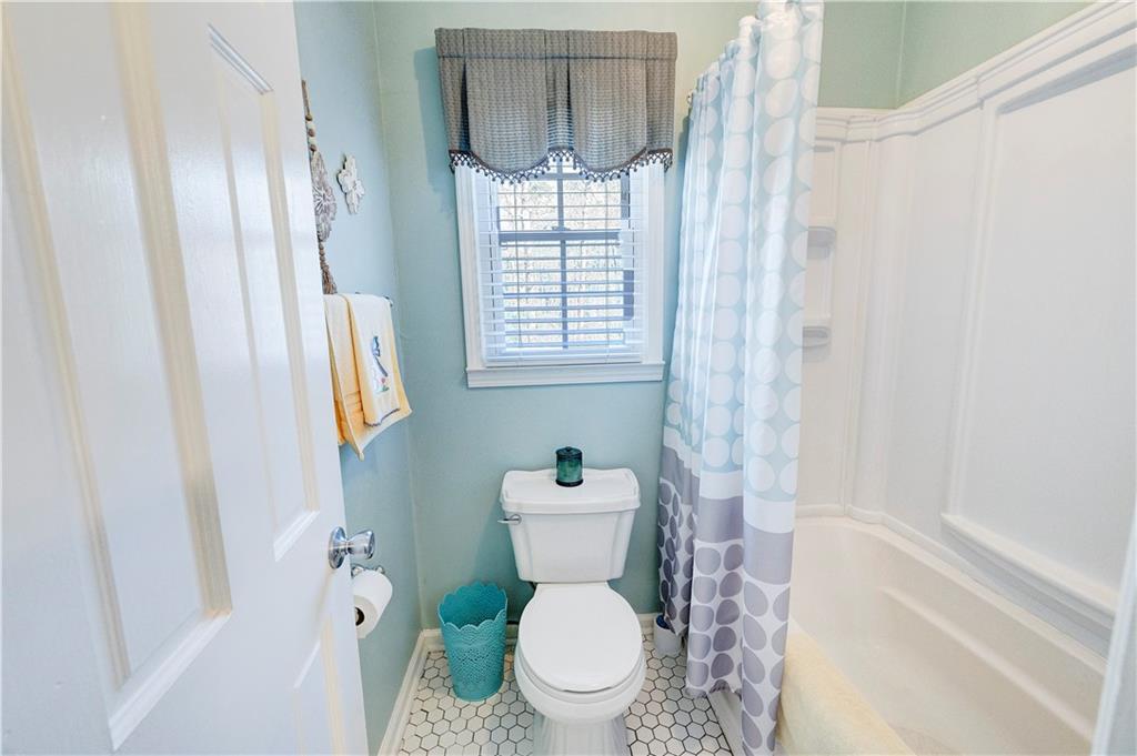 651 Camelot Circle Northwest Calhoun, GA 30701 - Photo 30 of 56 a white toilet sitting next to a bathroom sink