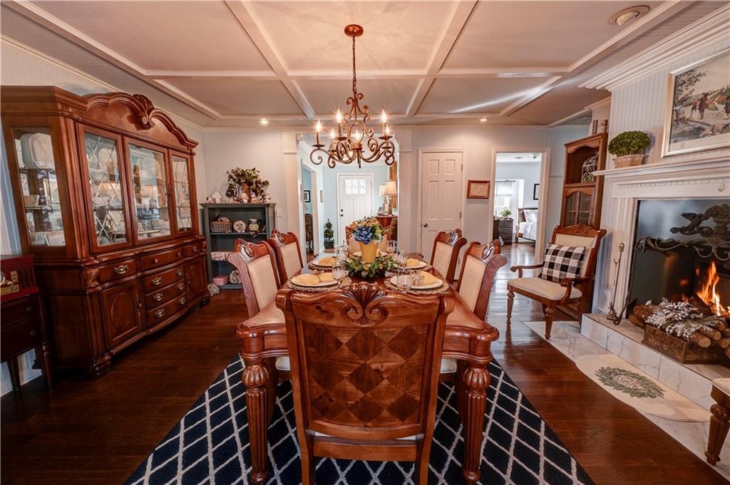 651 Camelot Circle Northwest Calhoun, GA 30701 - Photo 3 of 56 a view of a dining room with furniture a chandelier and wooden floor