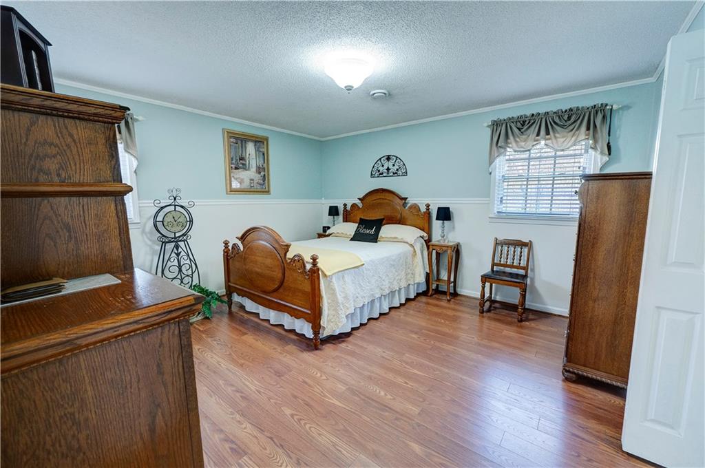 651 Camelot Circle Northwest Calhoun, GA 30701 - Photo 32 of 56 a bedroom with a bed and a window
