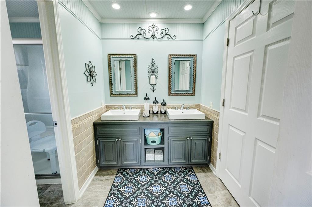 651 Camelot Circle Northwest Calhoun, GA 30701 - Photo 35 of 56 a bathroom with a double vanity sink and a mirror