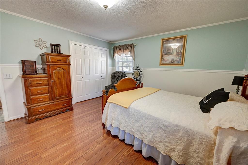 651 Camelot Circle Northwest Calhoun, GA 30701 - Photo 38 of 56 a bedroom with a bed and wooden floor