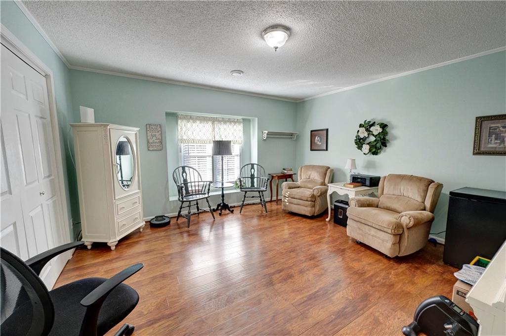 651 Camelot Circle Northwest Calhoun, GA 30701 - Photo 39 of 56 a living room with furniture mirror and wooden floor
