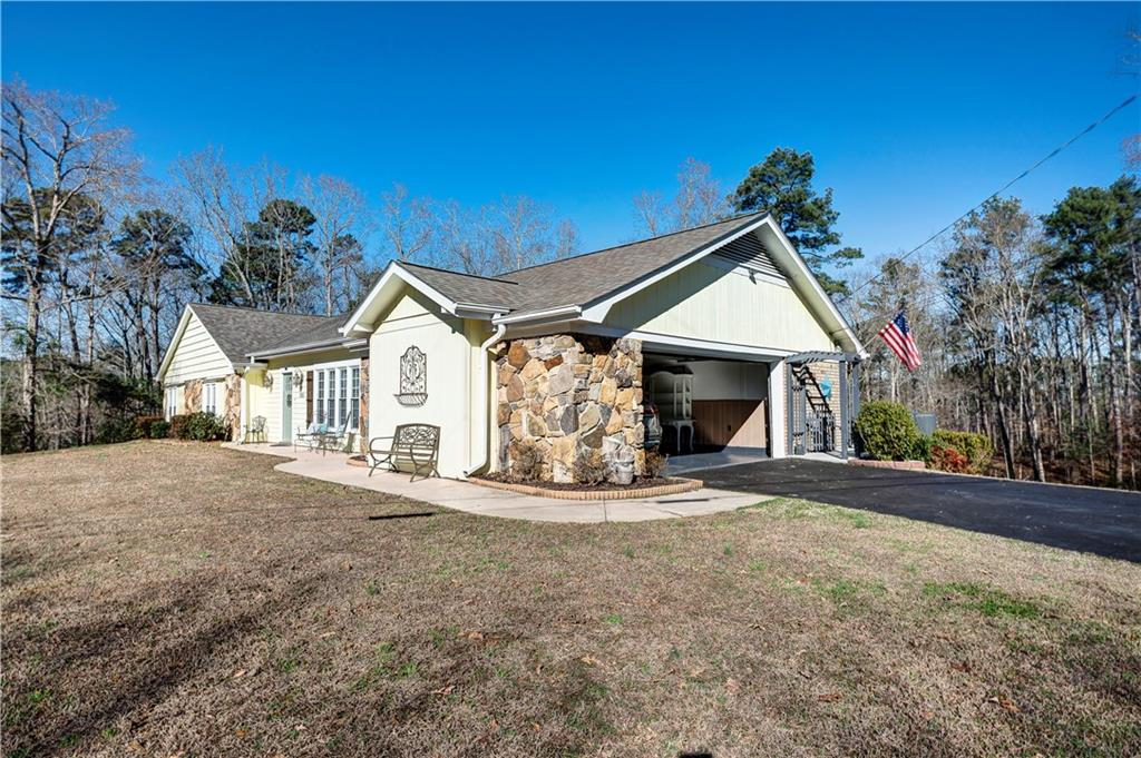 651 Camelot Circle Northwest Calhoun, GA 30701 - Photo 41 of 56 a view of a house with a yard and garage