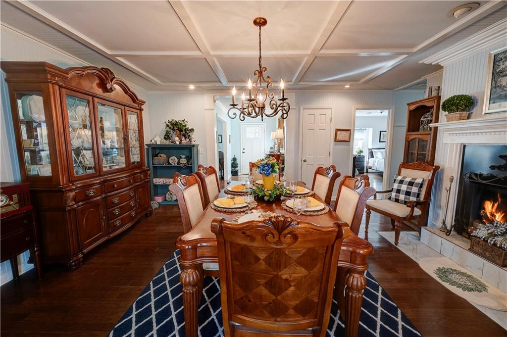 651 Camelot Circle Northwest Calhoun, GA 30701 - Photo 6 of 56 a view of a dining room with furniture a chandelier and wooden floor