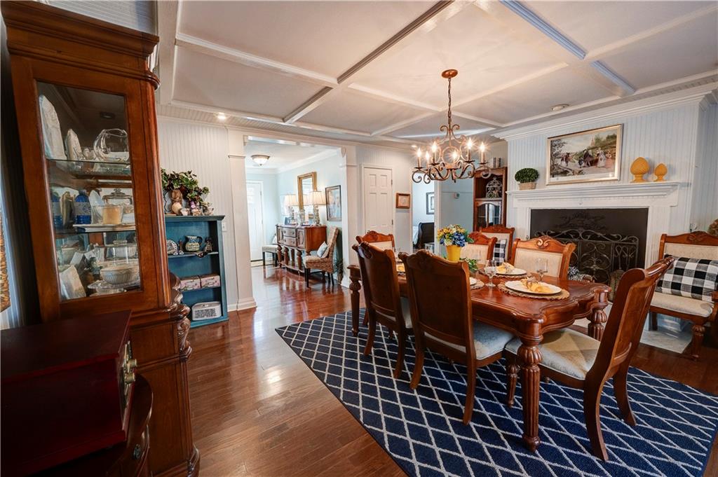 651 Camelot Circle Northwest Calhoun, GA 30701 - Photo 7 of 56 a view of a dining room with furniture wooden floor and chandelier