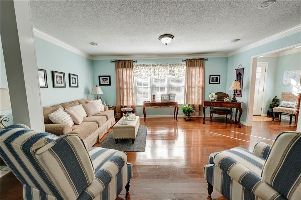 651 Camelot Circle Northwest Calhoun, GA 30701 - Photo 9 of 56 a living room with furniture and a large window