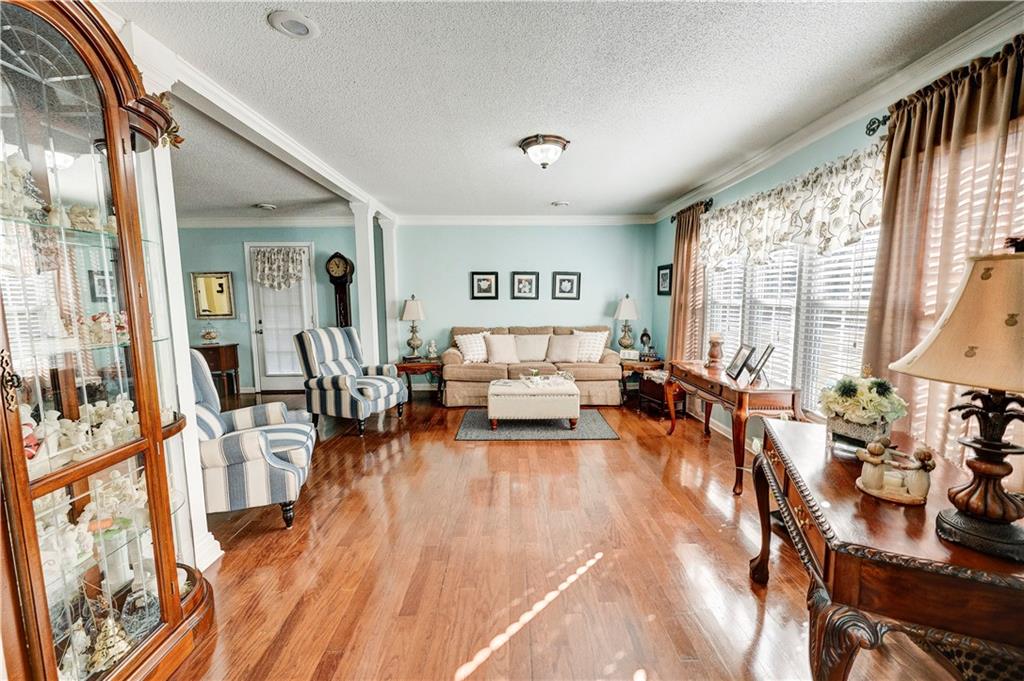 651 Camelot Circle Northwest Calhoun, GA 30701 - Photo 10 of 56 a living room with furniture and a large window