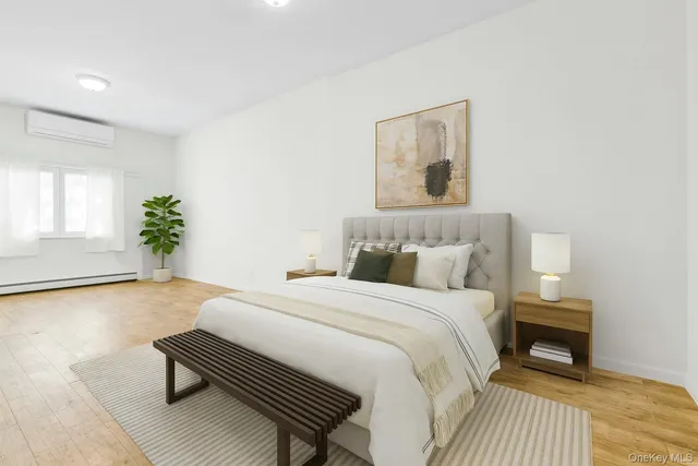 a bedroom with a bed and a potted plant