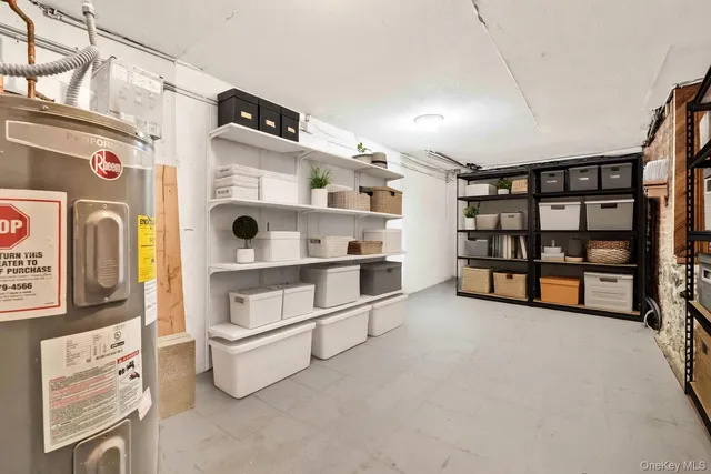 a view of an empty room with fridge and rack