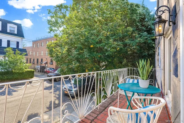 a view of a chair and tables in the balcony