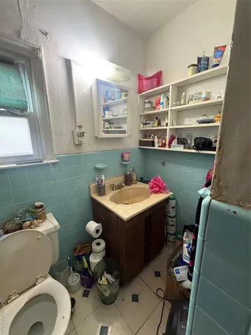 a bathroom with a sink toilet and a mirror