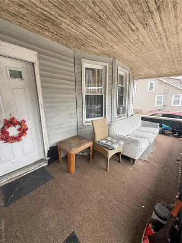 a view of a patio with a table and chairs and potted plants