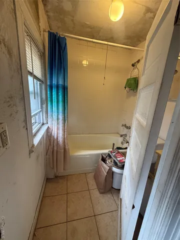 a bathroom with a bathtub and shower
