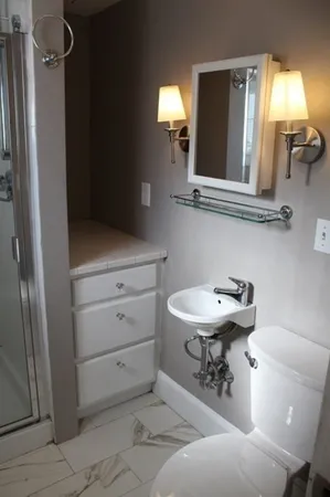 a room with a window and a chandelier fan