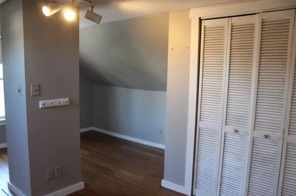 a bathroom with a granite countertop toilet sink and mirror