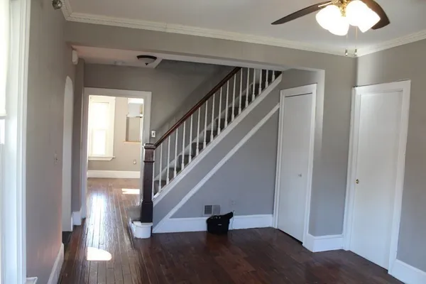 a view of entryway and hall with wooden floor