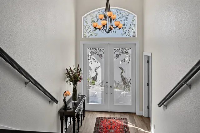a living room with furniture a fireplace and a large window