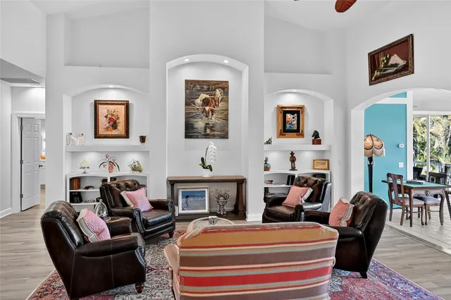 a dining room with furniture a chandelier and glass door
