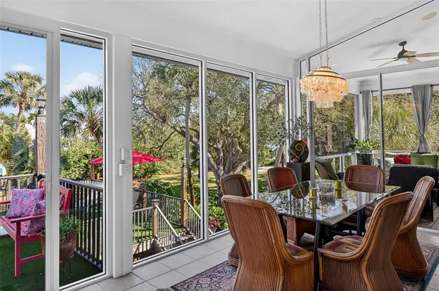 a view of a dining room with furniture a chandelier and wooden floor
