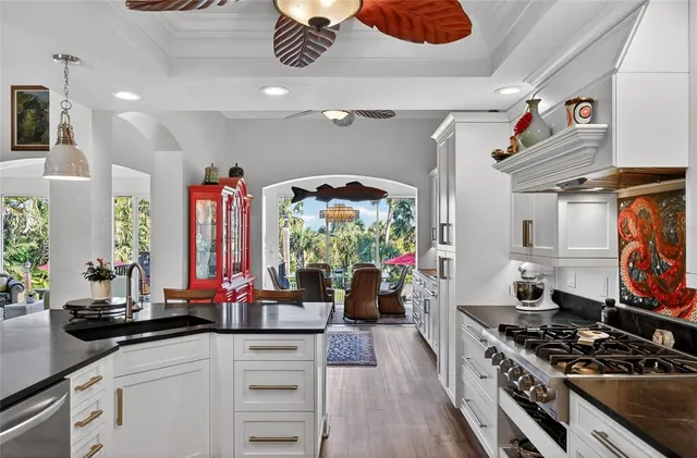 a living room with furniture a chandelier and a large window