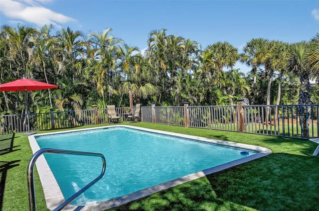 a view of a workspace with furniture and a bookshelf