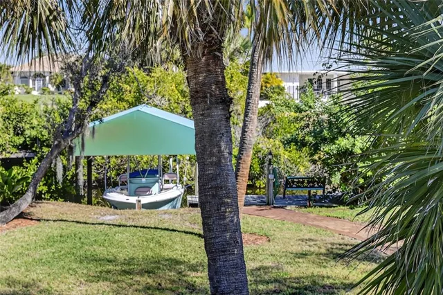 a kitchen with stainless steel appliances kitchen island granite countertop a sink and a wooden cabinets